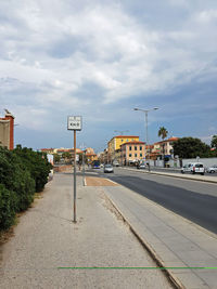 Road by city against sky