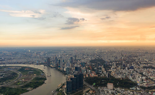 High angle view of city buildings against sky during sunset