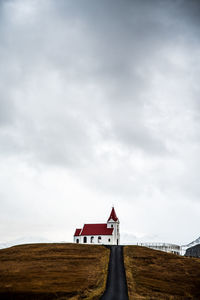 Low angle view of building on field against sky