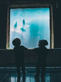 Full length of men in aquarium
