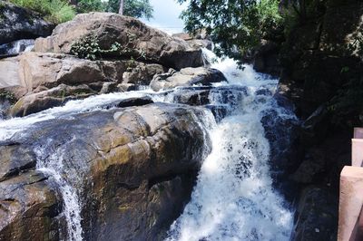 Scenic view of waterfall against sky