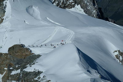 High angle view of people on snowcapped mountain