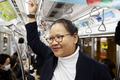 Portrait of man with eyeglasses in bus