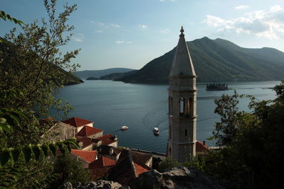 High section view of bell tower with mountain in background