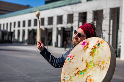 Man playing drum outdoors