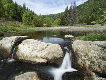 Scenic view of river flowing through rocks