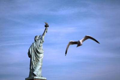 Statue of liberty in new york city, and flying seagull, freedom and hope