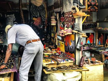 Rear view of man working at market