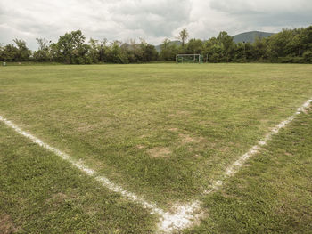 Scenic view of field against cloudy sky