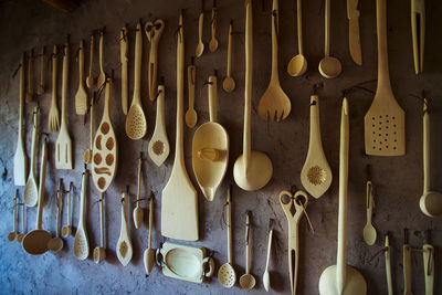 Close-up of kitchen utensils hanging on wall