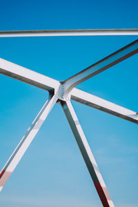 Low angle view of metallic structure against clear blue sky