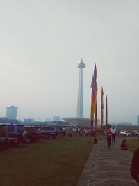 Group of people in city against sky