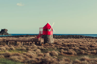 Lifeguard hut on beach against sky