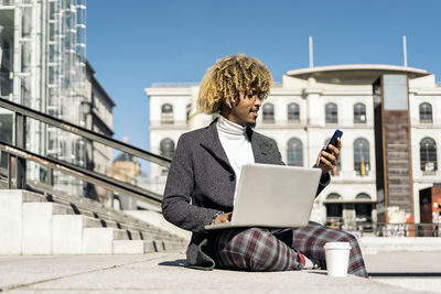 Man using mobile phone in city