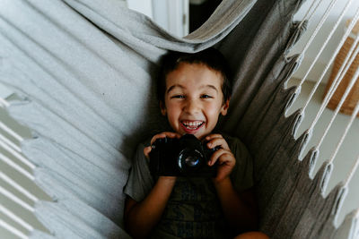 Portrait of happy boy photographing