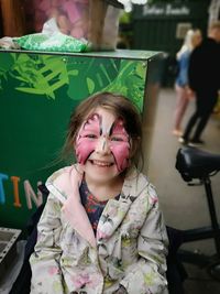 Portrait of smiling girl with face paint