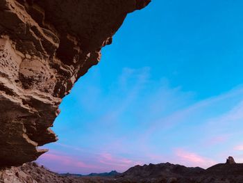 Scenic view of mountains against blue sky