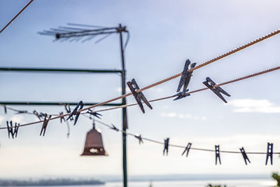 Low angle view of barbed wire against sky