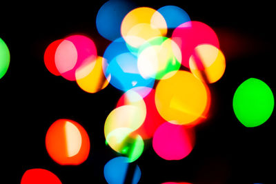 Close-up of multi colored lights against black background