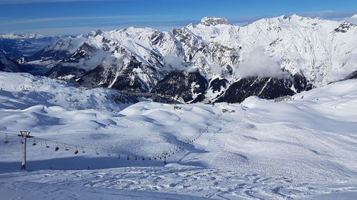 Scenic view of snow covered mountains against sky