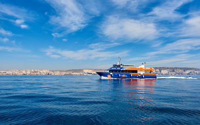 View of ship in sea against cloudy sky