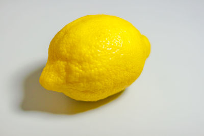 Close-up of yellow fruit against white background