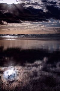 Scenic view of sea against cloudy sky