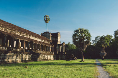 View of historic temple against blue sky during sunny day