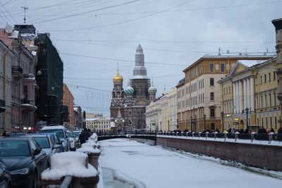 Street amidst buildings in city during winter