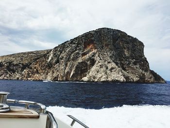 Scenic view of rock formation in sea against sky