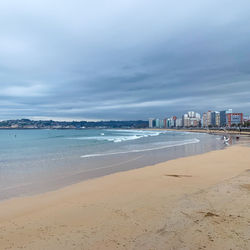 Scenic view of beach against sky in city