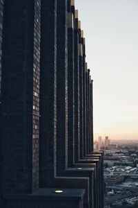 Modern buildings against sky during sunset