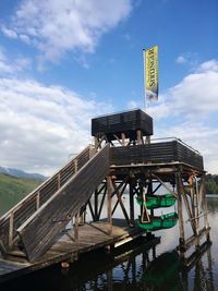 Low angle view of diving platform over lake millstatt against sky