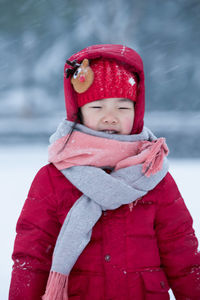 Close-up portrait of smiling girl in snow