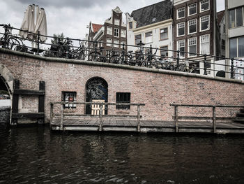 Building by river against sky