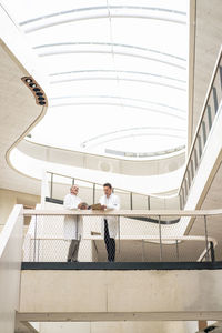 Doctors standing near railing in hospital corridor