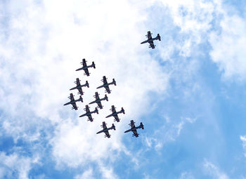 Low angle view of airplane flying against sky