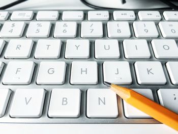 Close-up of pencil on computer keyboard