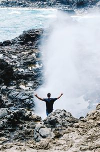 Woman jumping on rocks