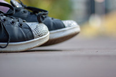 Close-up of shoes on cable car