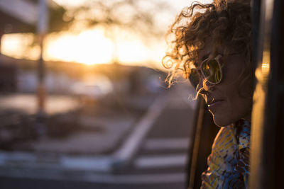 Woman looking away through car window