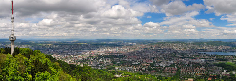 Cityscape against cloudy sky