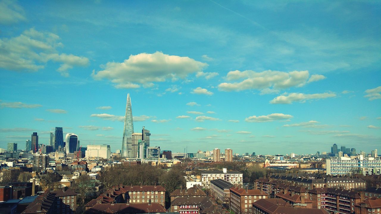 building exterior, architecture, cityscape, built structure, city, crowded, sky, residential district, blue, high angle view, residential building, tower, cloud - sky, residential structure, cloud, skyscraper, tall - high, city life, development, outdoors