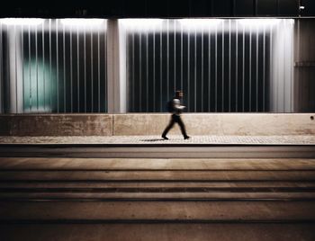 Blurred motion of person walking on road