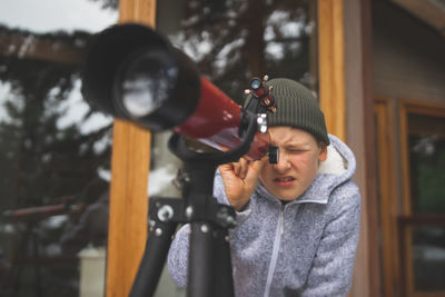 Boy looking through telescope