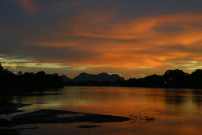 Scenic view of lake against orange sky