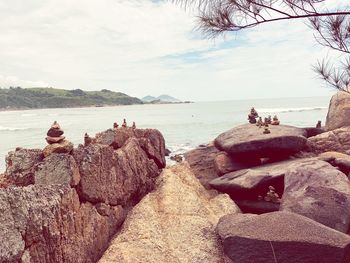 View of rocks on beach against sky