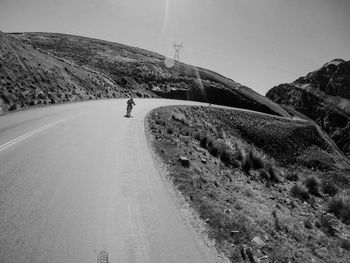 Empty road against sky - cycling to bolivia's yungas road aka road of death aka wmdr