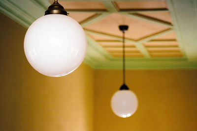 Close-up of light bulb hanging from ceiling