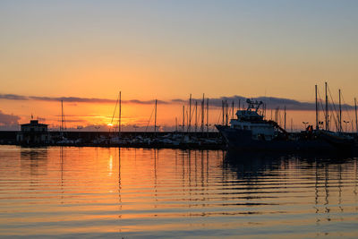 Boats moored at sunset